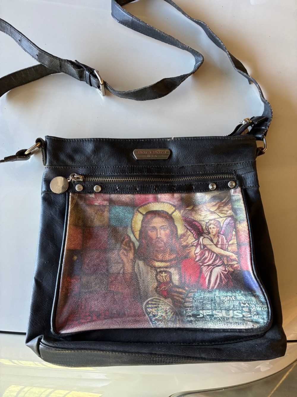 Black Crossbody Leather Bag with Religious Print on outside and floral print in